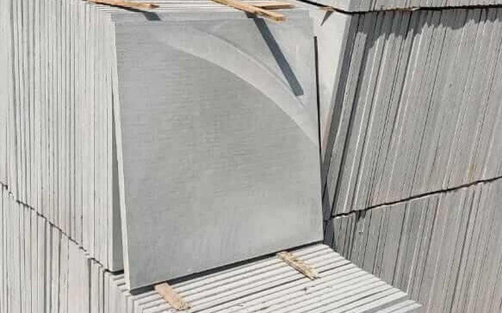 Stacked square Kota stone tiles in a grey-blue colour